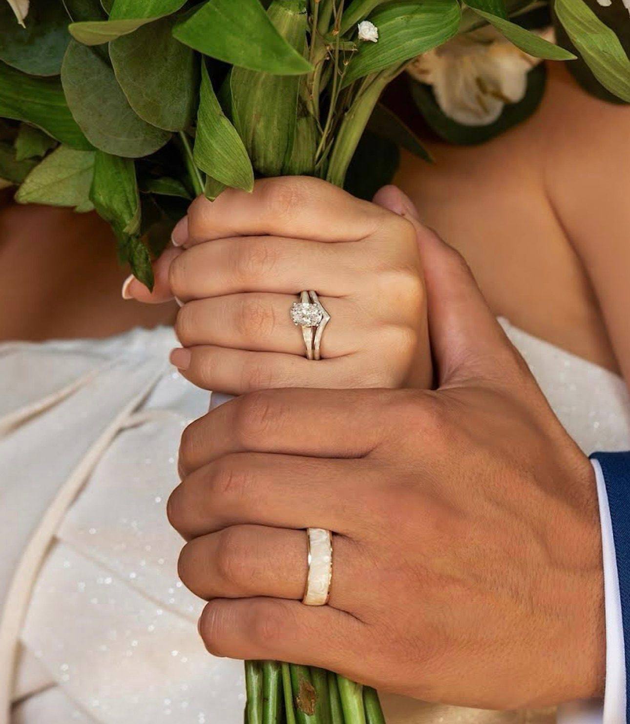 A man wearing a wedding band in an alternative metal, at Homsy Jewelers Boston
