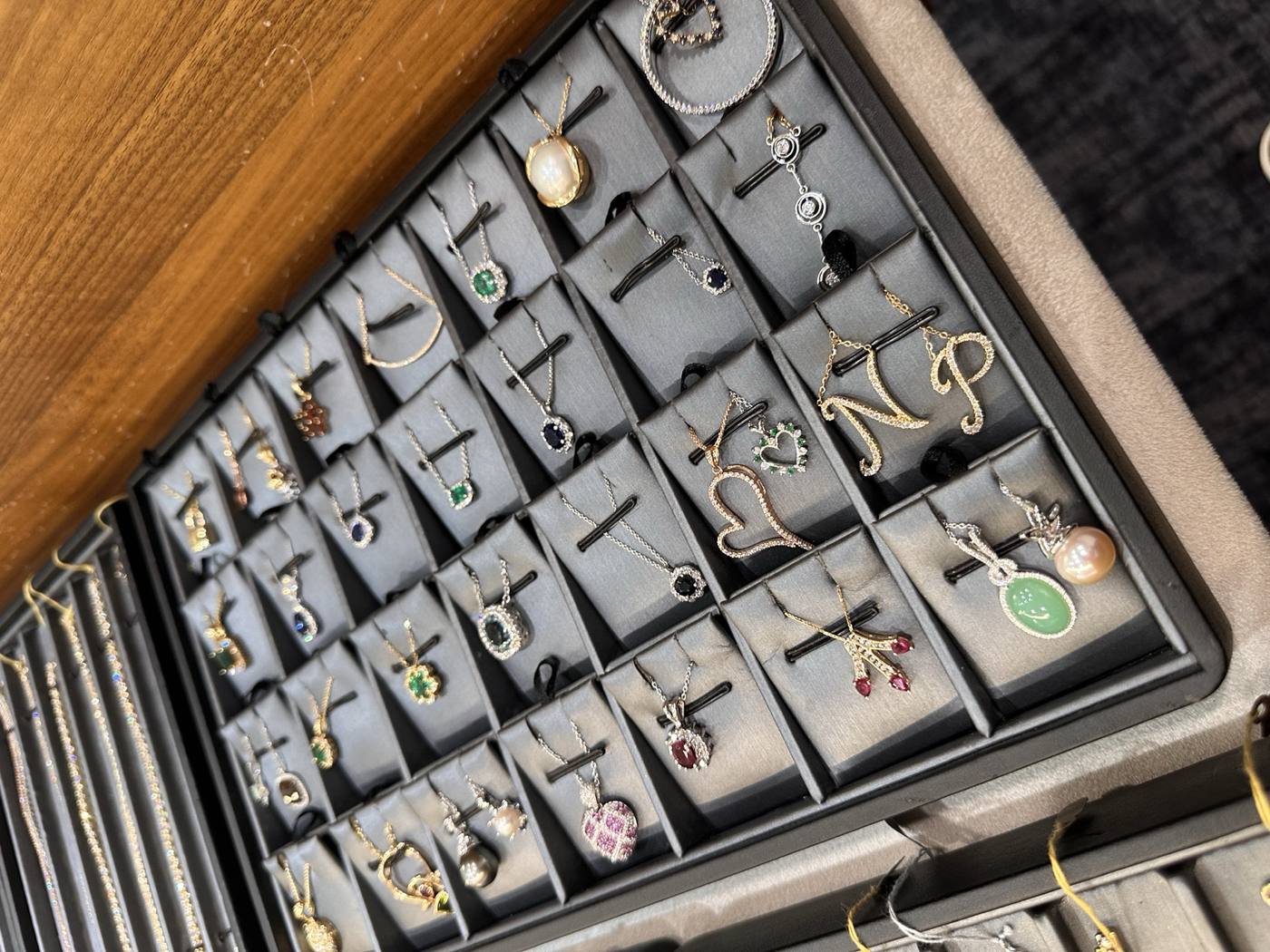 Estate pendant case with mixed gemstone pendants at Homsy Jewelers Boston