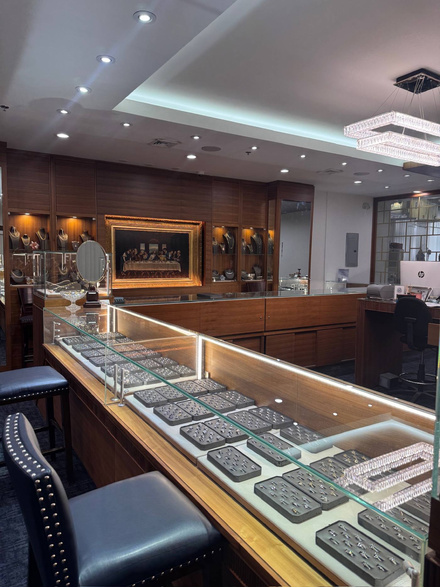 Interior of Homsy Jewelers in Downtown Boston, lit display cases and the Last Supper painting inside the Jewelers Building